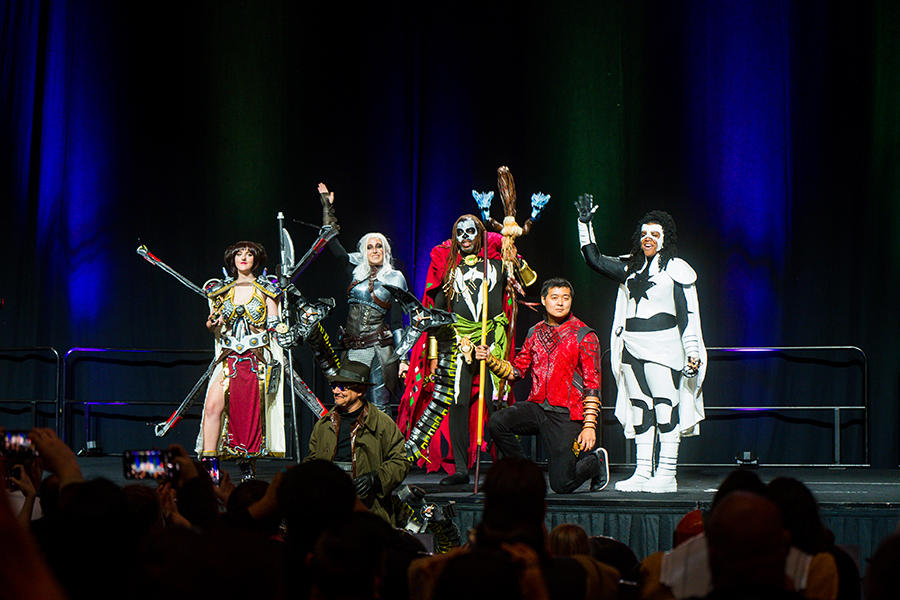 Group of people dressed up in costumes for Awesome Con