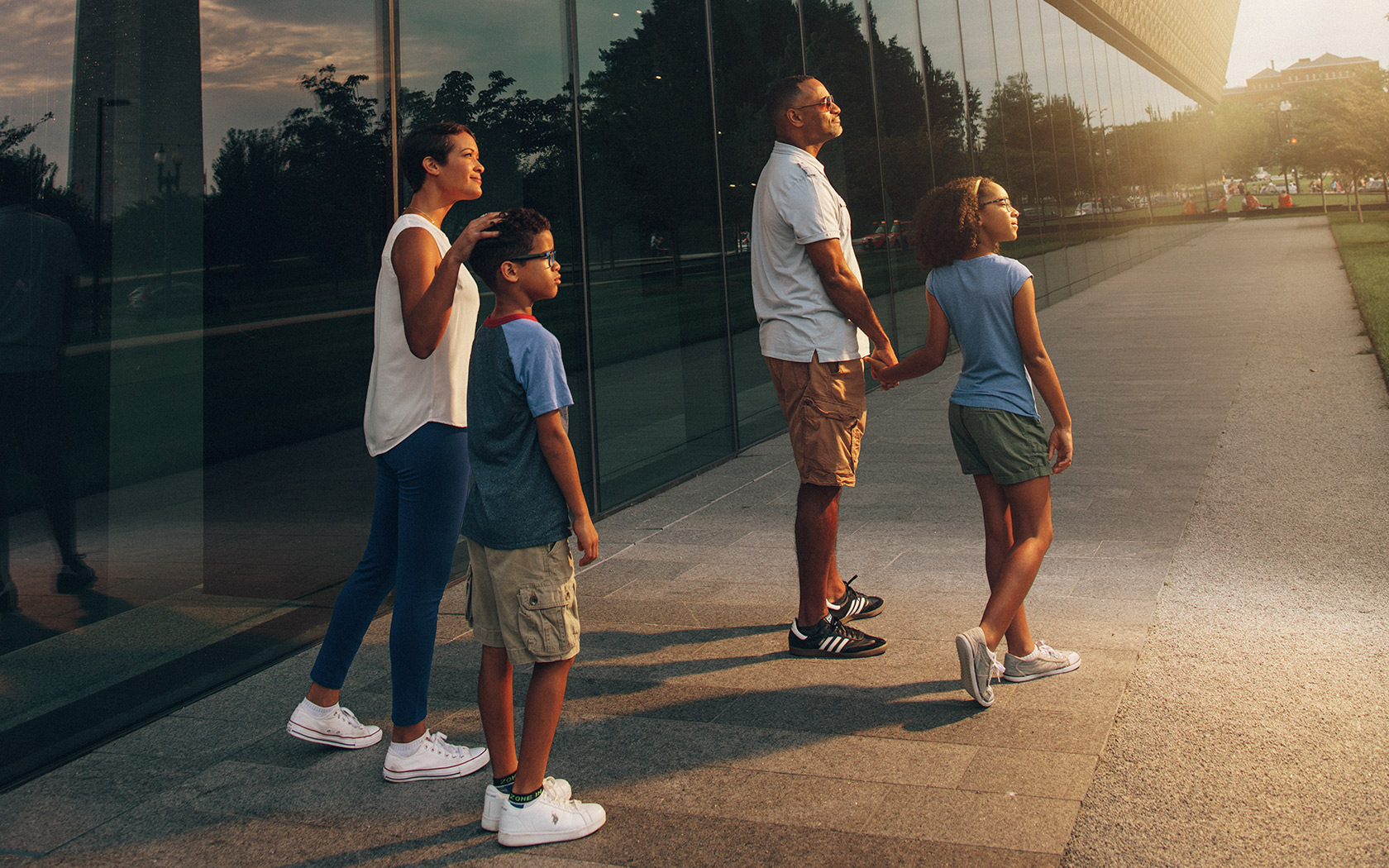 Family walking outside the National Museum of African American History and Culture